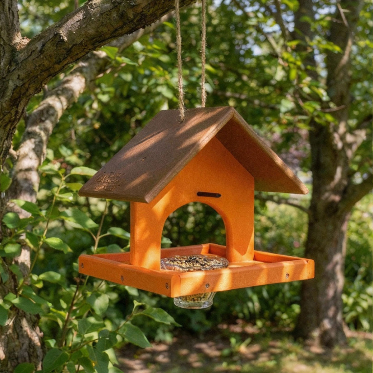USA-made oriole bird feeder with tray and jelly jar hanging from a tree